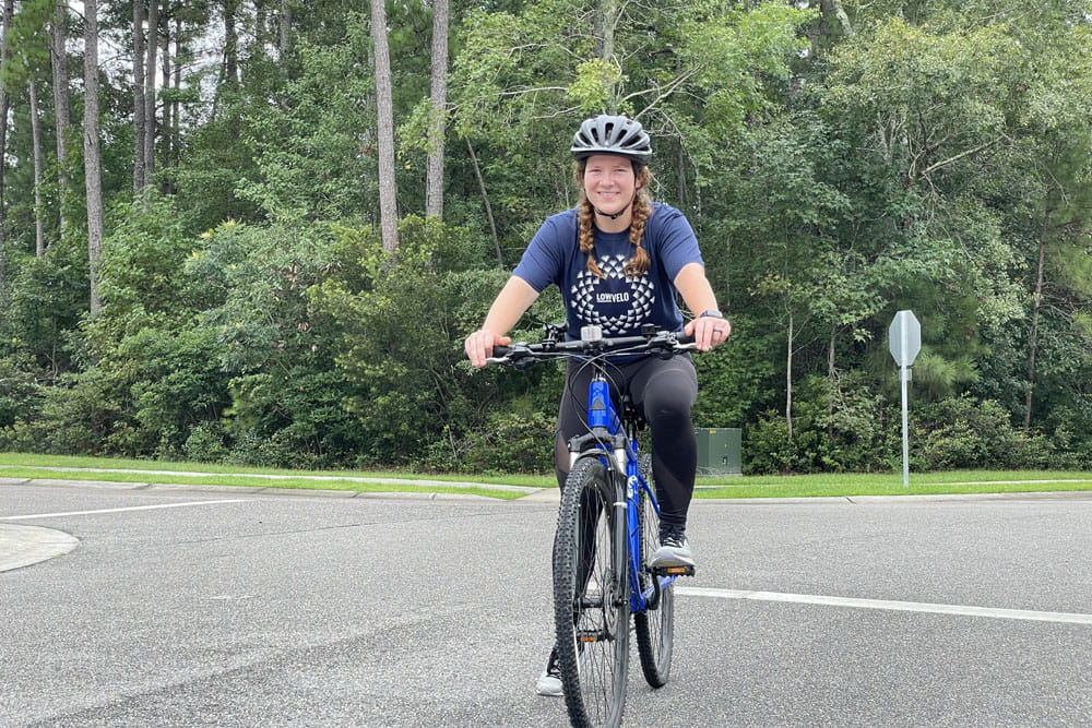 Rachel Burge riding a bicycle.