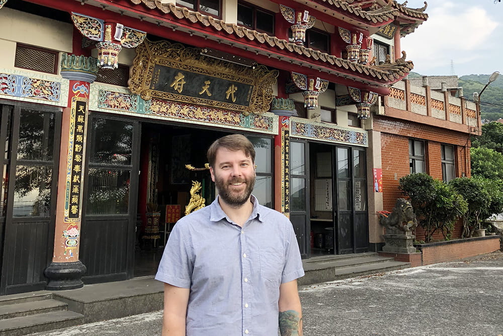 Matthew Greseth in front of temple in Taiwan