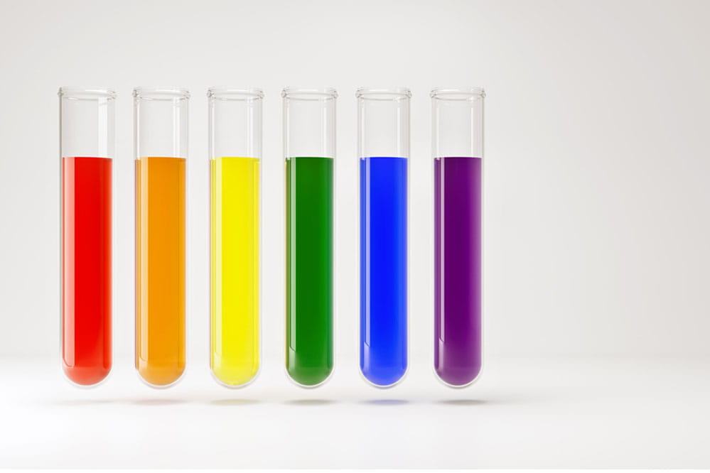 Test tubes with fluids in lgbt rainbow colors isolated on white.